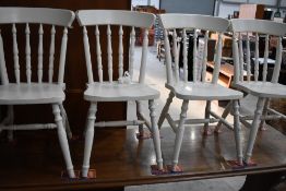 A set of four painted kitchen chairs