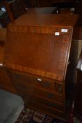 A reproduction burr walnut bureau
