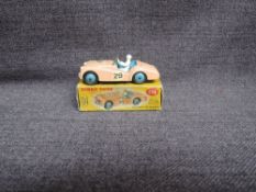 A Dinky diecast, 111 Triumph TR2 Sports, Pink with Blue Hubs in original correct spot box