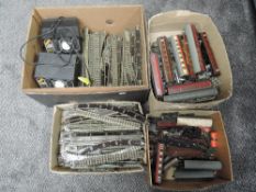 A shelf containing four boxes of 00 gauge tree rail Track, Rolling Stock and Accessories