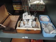 A shelf of Dolls house china Tea Sets, modern furniture and two small wooden boxes