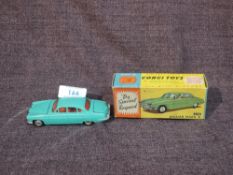 A Corgi diecast, 238 Jaguar Mark X in sea green with red interior, both plastic suitcases present,