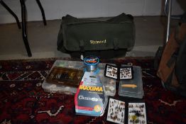 A Wychwood fishing bag containing flies lures and line