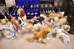 A mixed lot of vintage dog studies, including Beswick West Highland terrier, Hummel dog nursing