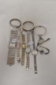 Ten ladies gold tone watches, one having black face with bronze/copper details.