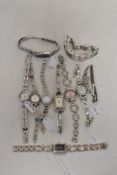 Ten ladies watches all having gold or silver tone accents.