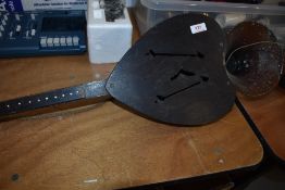 A vintage instrument, possibly a phono fiddle or similar