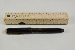 A boxed Parker Vacumatic plunger fill fountain pen in black with transparent barrel having two