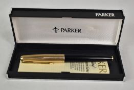 A boxed Parker 61 converter fountain pen in black with rolled gold cap. Approx 13.4cm in good