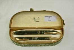 A Burnham fountain pen and propelling pencil set in grey/ green marble having two bands to the