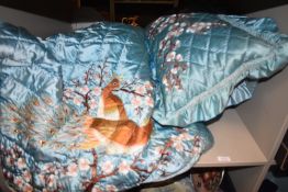 A vintage Chinese satin bedspread and pillow case set having extensive embroidery.