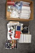 A selection of tattoo equipment including guns, needles, and paper transfer designs