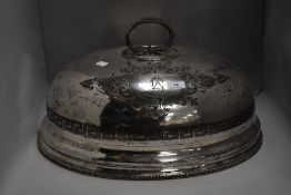A large Victorian silver plated cloche having a Greek key design with rope twist handle.