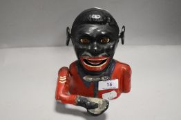 A vintage reproduction cast metal mechanical money box or bank