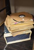 An early 20th century Emerson portable vinyl record player in a green case, with a selection of