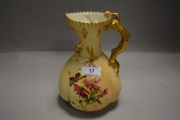 An early 20th century Royal Worcester blush ivory hand decorated ewer having a hand painted flower