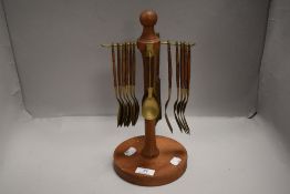 A mid century brass and teak handled cutlery set