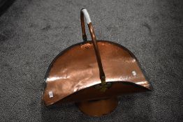A 20th century large copper log trugg with footed base and hammered finish