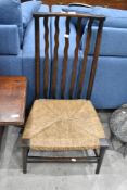 A 19th Century low rush seated chair having wave rail back