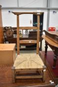 A 19th Century low seat ladder back chair having strung seat