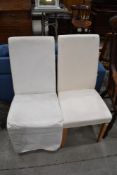 A pair of modern upholstered dining chairs