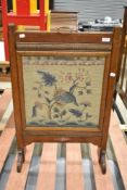 An early 20th Century oak tapestry fire screen