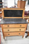 A late 19th Century golden oak washstand having slate top and back