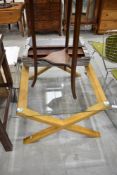A modern glass top coffee table having wood X frame, approx. 100 x 75cm