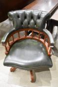 A modern office green leather swivel armchair