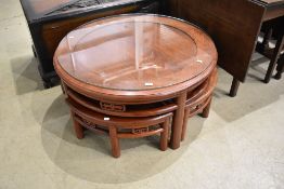 An Oriental hardwood coffee table nest