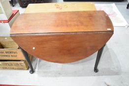 A 19th Century mahogany table having Queen Anne style gate legs