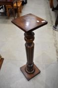A traditional stained frame torchere/plant stand