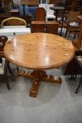 A modern pine circular dining table