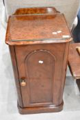 A 19th Century mahogany bedside cabinet, having plum pudding style finish