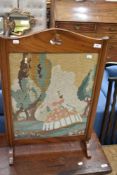 A stained frame fire screen having crinoline lady panel