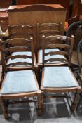 A set of four Priory style shaped ladder back dining chairs