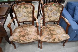 A pair of reproduction Continental style armchairs
