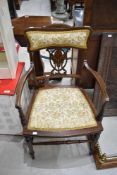 An Edwardian mahogany salon armchair