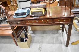 A modern mahogany side table having three drawers