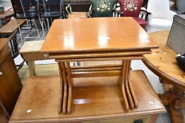 A vintage teak nest of three tables
