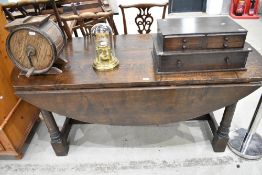 A reproduction oak banquetting style drop leaf table on chunky frame, large proportions