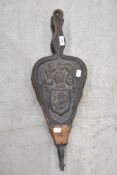 A traditional set of bellows with carved coat of arms style decoration
