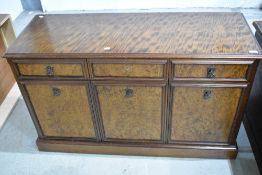 A modern sideboard base having walnut panelled doors, width approx. 121cm