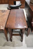 A traditional oak gateleg dining table having turned frame