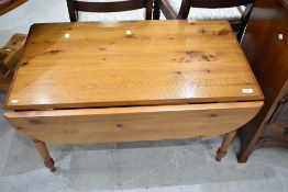 A modern pine drop leaf coffee table