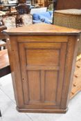 A 19th Century oak corner cupboard having panelled door , height approx. 116cm