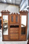 An impressive Victorian mahogany wardobe having central cupboard and drawer section , flanked by two