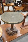 An Anglo Indian style brass top occasional table having turned column and stepped base