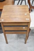 A vintage sewing table and contents including haberdashery, patterns, bobbin reels etc
