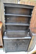 A dark stained Priory style dresser, width approx. 85cm